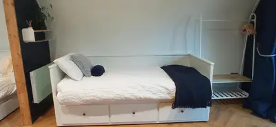 a small white bed in a small room at little peru luxury pods and alpaca farm in Crosshill