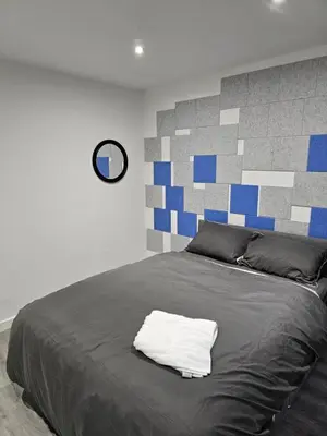 a bedroom with a bed with a white towel on it at Bridgepay Modern 4 bedroom House in Cumbria - Whitehaven - Free Parking in Whitehaven