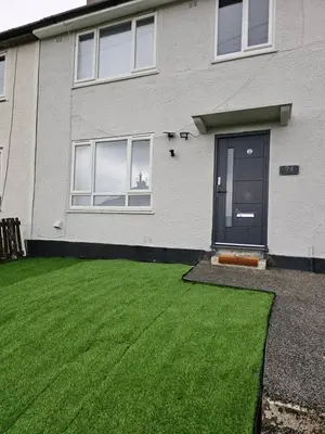 a house with a green lawn in front of it at Bridgepay Modern 4 bedroom House in Cumbria - Whitehaven - Free Parking in Whitehaven