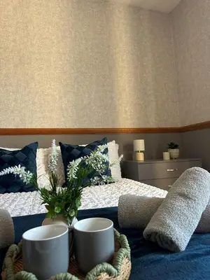 a bedroom with a bed with two bowls on it at Bolton Terrace - 2 Bedrooms - Sleeps 4 in Workington