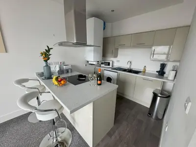 a kitchen with white cabinets and a counter top at Harbour View - 1 Bedroom - Sleeps 2 in Whitehaven