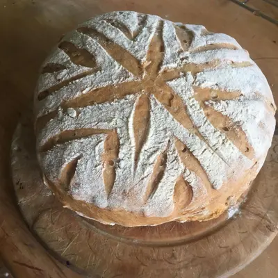 a cake sitting on a glass plate on a table at Gilchristland Organic Farm Retreat in Closeburn