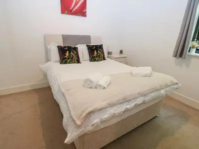 a bedroom with a bed with two towels on it at Sea View Apartment - 2 Bedrooms - Sleeps 4 in Whitehaven