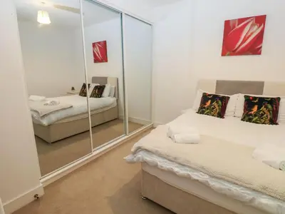 a bedroom with two beds and a mirror at Sea View Apartment - 2 Bedrooms - Sleeps 4 in Whitehaven