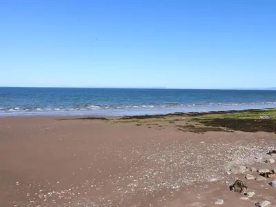an empty beach with the ocean in the background at Sea View Apartment - 2 Bedrooms - Sleeps 4 in Whitehaven