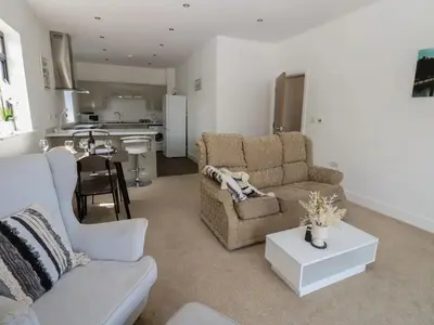 a living room with a couch and a table at Sea View Apartment - 2 Bedrooms - Sleeps 4 in Whitehaven
