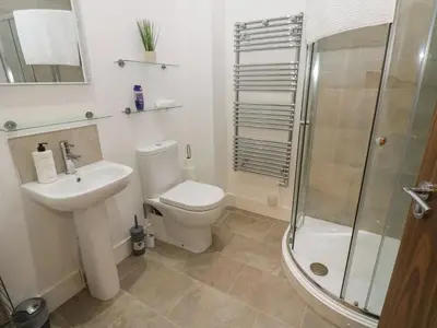 a bathroom with a toilet and a sink and a shower at Sea View Apartment - 2 Bedrooms - Sleeps 4 in Whitehaven