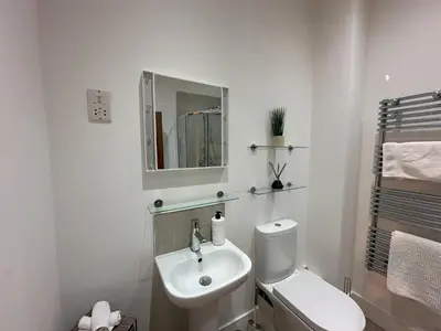 a white bathroom with a toilet and a sink at Sea View Apartment - 2 Bedrooms - Sleeps 4 in Whitehaven