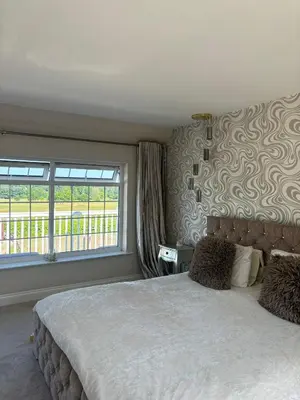 a bedroom with a large bed and a window at Brig o Doon 2 in Ayr