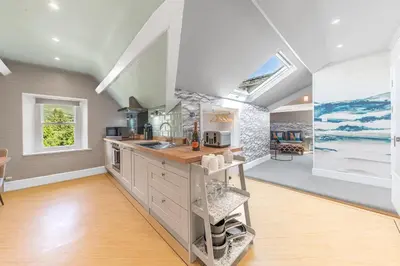 a kitchen with a sink and a counter top at Fell215 - Classic loft apartment at The Lairbeck in Keswick in Keswick