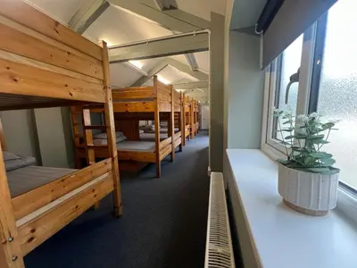 a row of bunk beds in a room at Denton House Hostel in Keswick