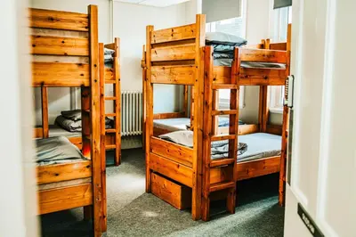 a group of bunk beds in a room at Denton House Hostel in Keswick