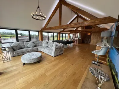 a living room with a couch and a table at Blencathra Barn in Penrith