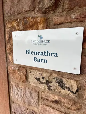 a sign on a brick wall with the name of a brewery at Blencathra Barn in Penrith