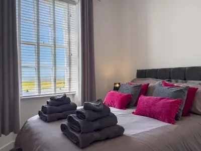 a bedroom with a bed with towels on it at North Lodge Retreat Allonby in Maryport