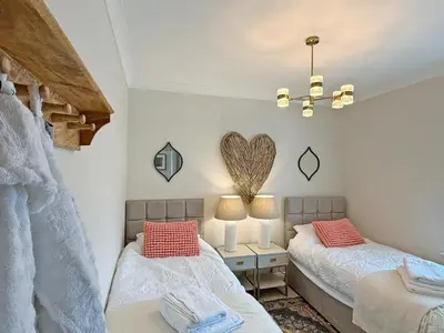 two beds in a room with a heart on the wall at The Guards Quarters - Uk47594 in Silloth