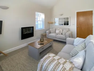 a living room with a couch and a tv at The Guards Quarters - Uk47594 in Silloth