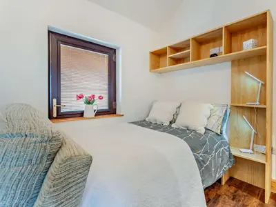 a bedroom with a bed and a window and a couch at 1 Bed in Allonby 95499 in Allonby