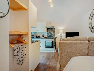a living room with a couch and a kitchen at 1 Bed in Allonby 95499 in Allonby