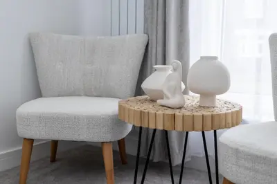 a table with a chair and a vase on it at Tranquil House with Sea Views in Parton