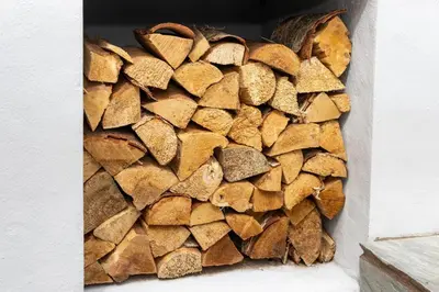a pile of wood on the side of a wall at Tranquil House with Sea Views in Parton