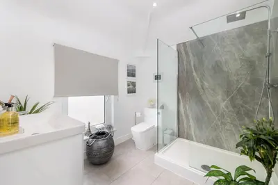 a bathroom with a shower and a toilet and a sink at Tranquil House with Sea Views in Parton