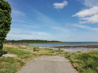 a path leading to a beach with the ocean at Ptarmigan in Newton Stewart