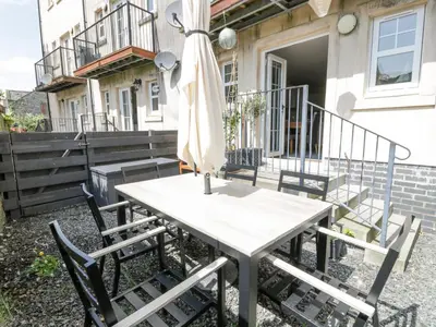 a table with chairs and an umbrella on a patio at Ptarmigan in Newton Stewart