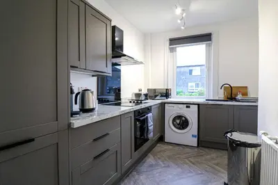 a kitchen with a washer and dryer at Marchfield Promenade View in Prestwick