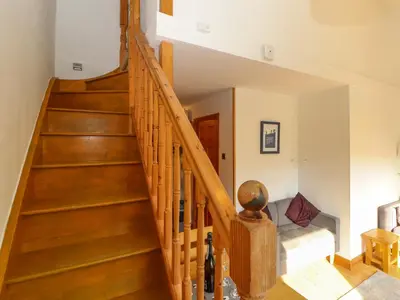 a staircase in a home with wooden floors at Bluebells in Ambleside