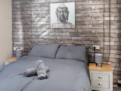 a bed with a stuffed animal on top of it at Zion's Retreat in Plumbland