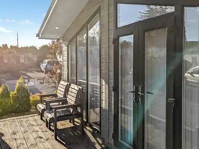 a porch with two benches on a house at Zion's Retreat in Plumbland