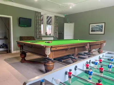 a room with a pool table and some toy figures at Bank House Longtown, ideal group accommodation with swimming pool & hot tub in Longtown