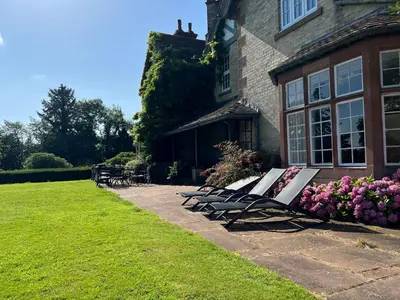 a group of benches sitting outside of a house at Bank House Longtown, ideal group accommodation with swimming pool & hot tub in Longtown