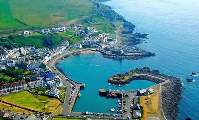 an aerial view of a harbor with boats in the water at Doonhill in Portpatrick in Portpatrick