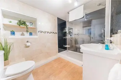 a bathroom with a toilet and a sink and a shower at 4BR Holiday Home Steps from Keswick Town Centre in Keswick