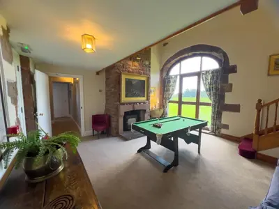 a living room with a ping pong table in it at Kirk House Longtown, ideal for groups or families holidaying together in Longtown