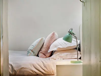 a bedroom with a bed with pillows and a lamp at 4 Bed in Buttermere oc-sz090 in Buttermere