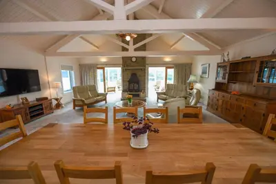 a large living room with a table and chairs at Braesyde in Kippford