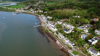 an aerial view of a town next to the water at Braesyde in Kippford