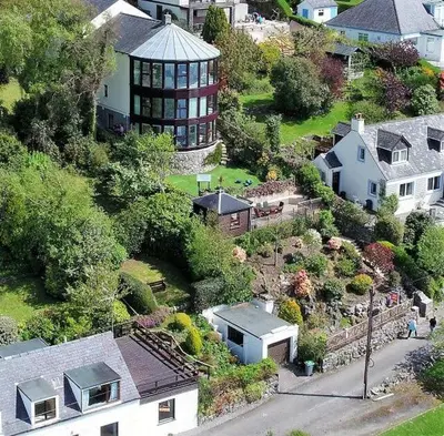 an aerial view of a house with a garden at Braesyde in Kippford