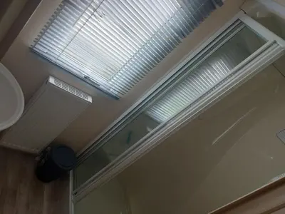 a bathroom with a window and a door at Victoria's Caravans in Ayr