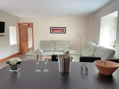 a living room with a table and wine glasses at Dungavel Cottage in Roberton