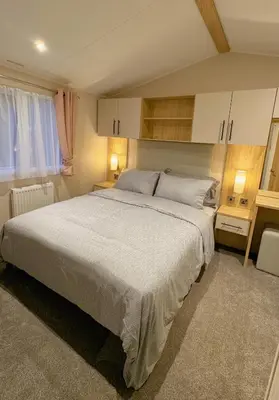 a bedroom with a large bed in a room at Carlisle CAMELOT HOLIDAY PARK CA65SZ MANOR in Longtown