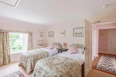 two beds in a room with a window at Bellrigg in Castle Douglas