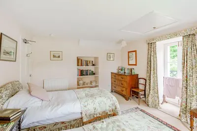 a bedroom with a bed and a book shelf at Bellrigg in Castle Douglas