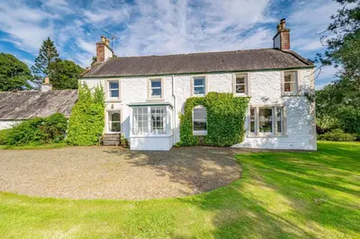 a large white brick house with a yard at Bellrigg in Castle Douglas
