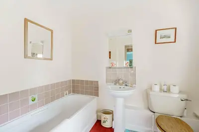 a bathroom with a tub and a sink and a toilet at Bellrigg in Castle Douglas