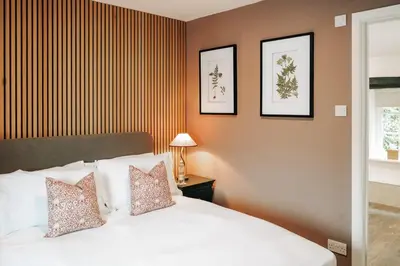 a bedroom with a white bed with two pillows at The Swinside Inn in Keswick