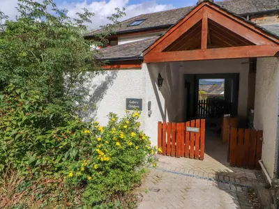 an entrance to a house with a wooden gate at Gallery Cloisters in Keswick